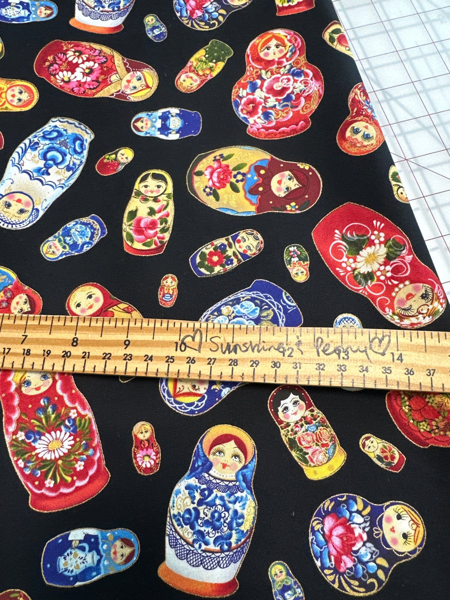 Matryoshka - Tossed Dolls Metallic Black from Elizabeth’s Studio Fabric