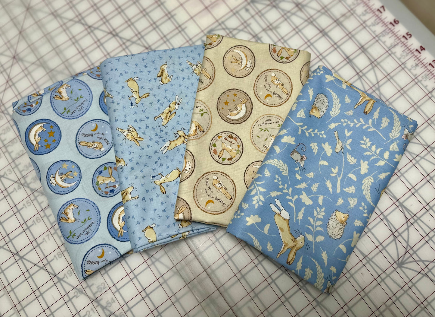 Clothworks - Guess How Much I Love You 2024 Collection - Tossed Bunnies - Light Denim - Priced by the half metre